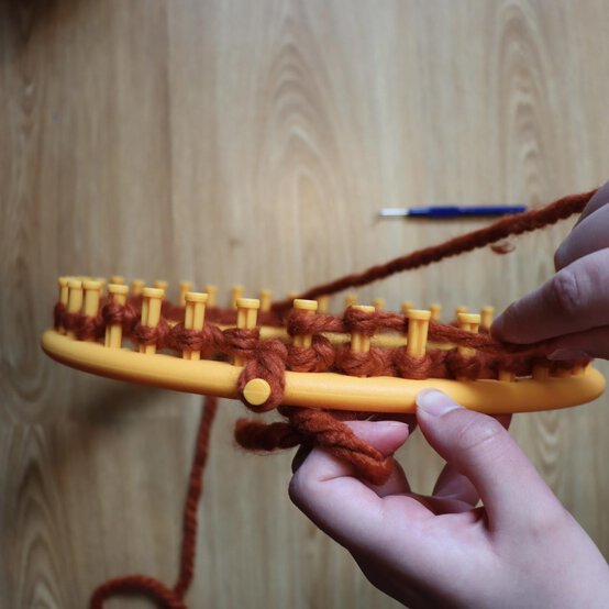 how_to_loom_knit_a_twisted_ear_warmer_step_5a.jpg?sw=554&q=85