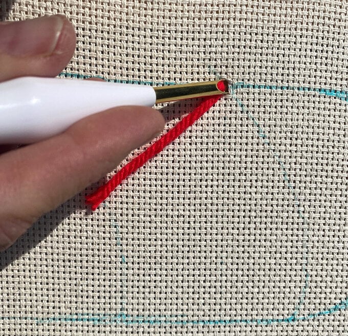 how-to-punch-needle-a-candy-cane-cushion_step_4_first_stitch.jpg?sw=680&q=85