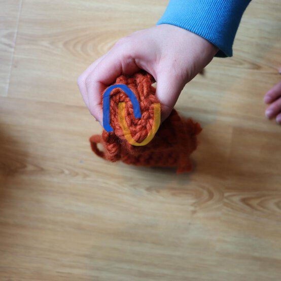 how_to_loom_knit_a_twisted_ear_warmer_step_9a.jpg?sw=554&q=85