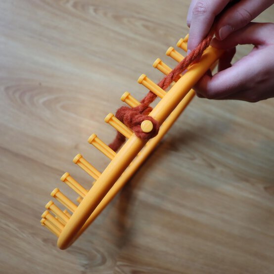 how_to_loom_knit_a_twisted_ear_warmer_step_2a.jpg?sw=554&q=85