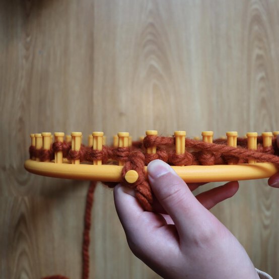 how_to_loom_knit_a_twisted_ear_warmer_step_4.jpg?sw=554&q=85