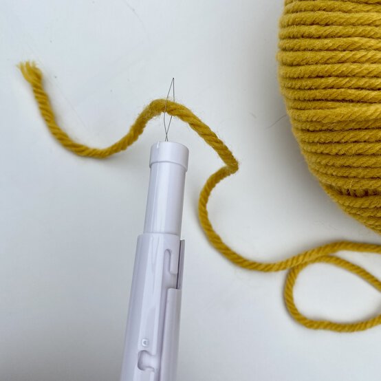 how-to-make-a-punch-needle_sunburst_threading_yarn_step_4.jpg?sw=554&q=85