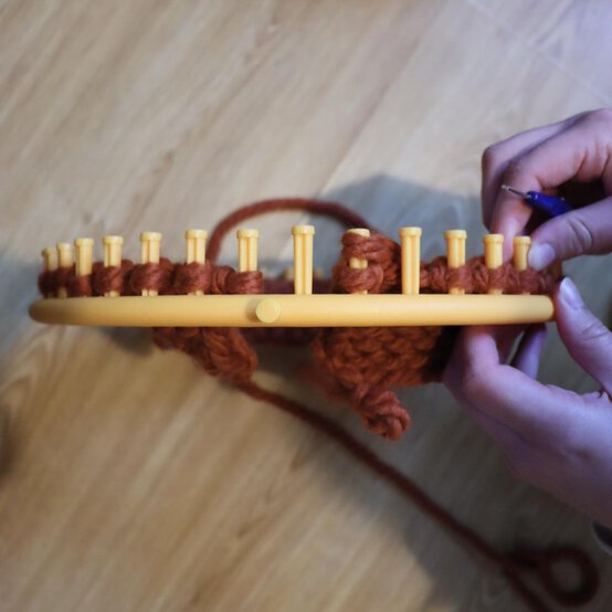 how_to_loom_knit_a_twisted_ear_warmer_step_8g.jpg?sw=554&q=85