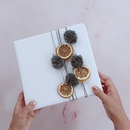 how_to_gift_wrap_with_your_yarn_scraps_pom-pom-final.png?sw=554&q=85