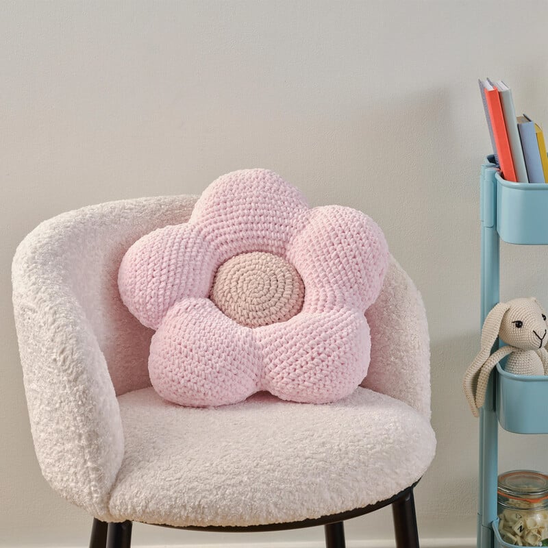 A large crocheted flower cushion on a chair. Clicking leads to all ideas and projects