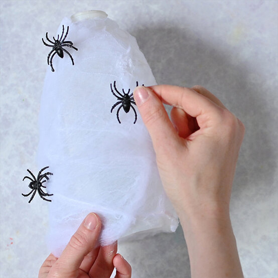 how-to-make-halloween-milk-bottle-lanterns_spiders-d.jpg?sw=554&q=85