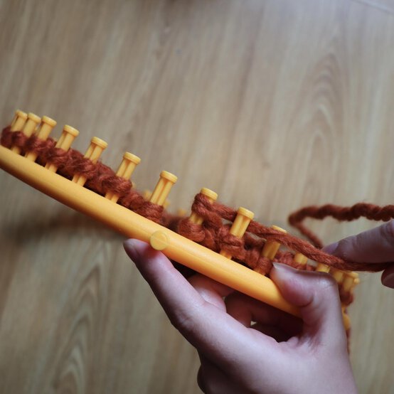 how_to_loom_knit_a_twisted_ear_warmer_step_7b.jpg?sw=554&q=85